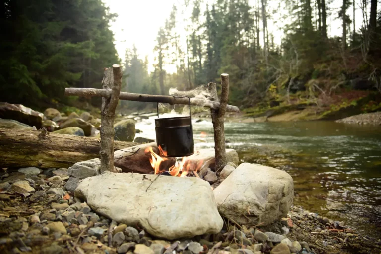 A hunters campsite cooking over a campfire