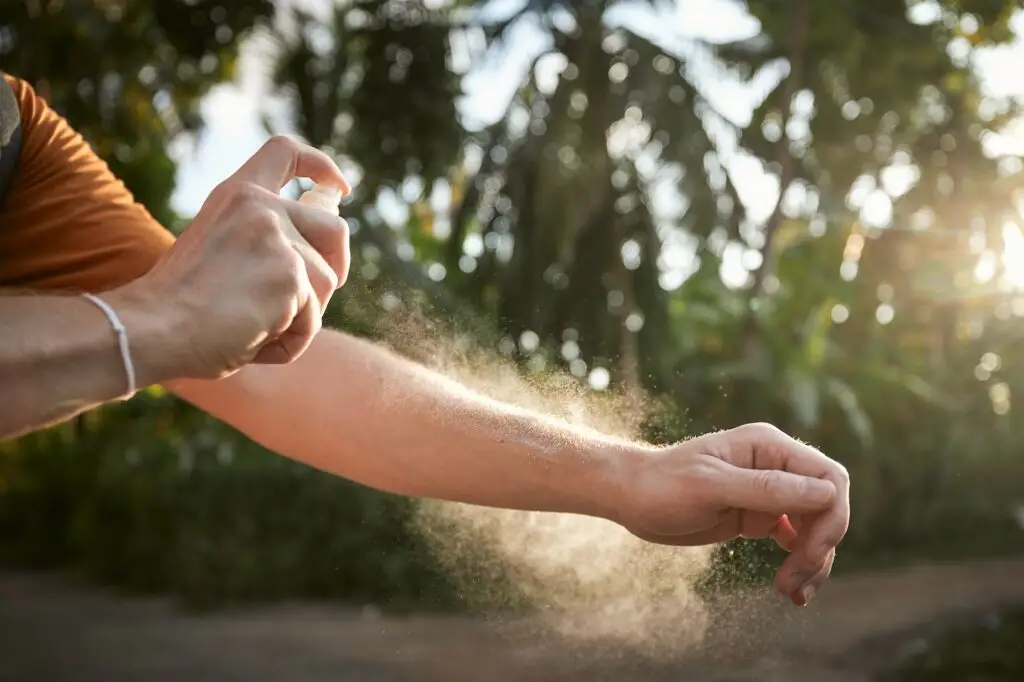 Man applying insect repellent on his hand