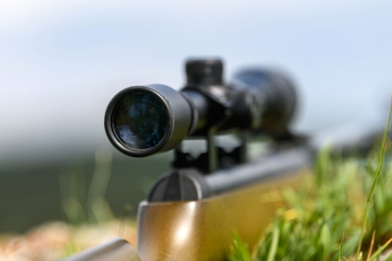 Rifle scope on the street with blurry background. Hunting concept