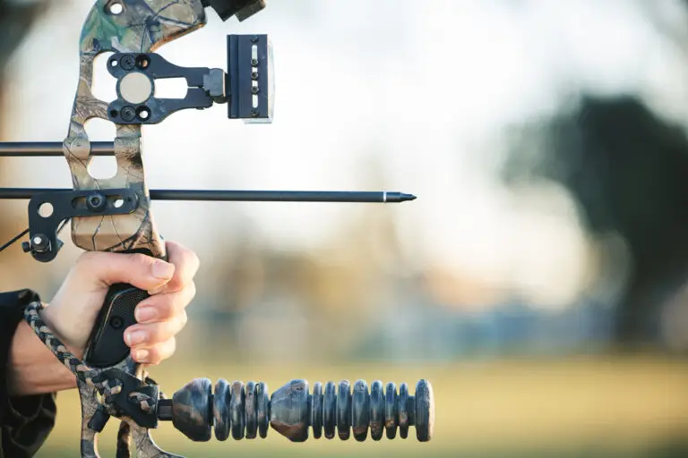 Archery bow and closeup of person at shooting range for competition, game or learning in field or o
